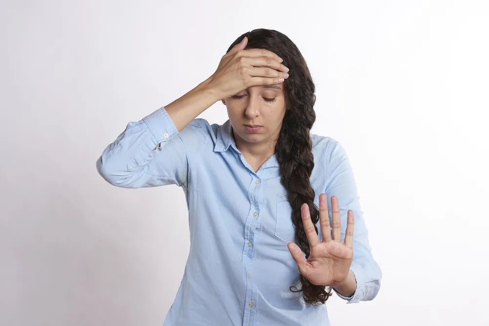 A person showing visible signs of stress and exhaustion, reflecting the toll of shift work and physically demanding jobs