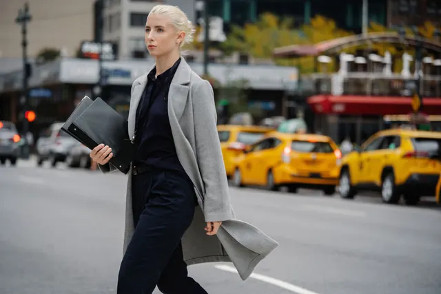 Person standing at the edge of a bold leap forward — representing the transition from employee to entrepreneur and the mindset required to build your own business