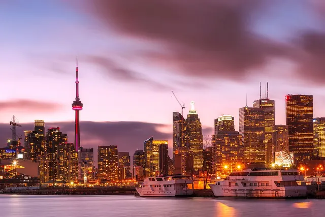 Toronto's skyline glowing at dusk, representing the real pathways young people need to build a future in Canada