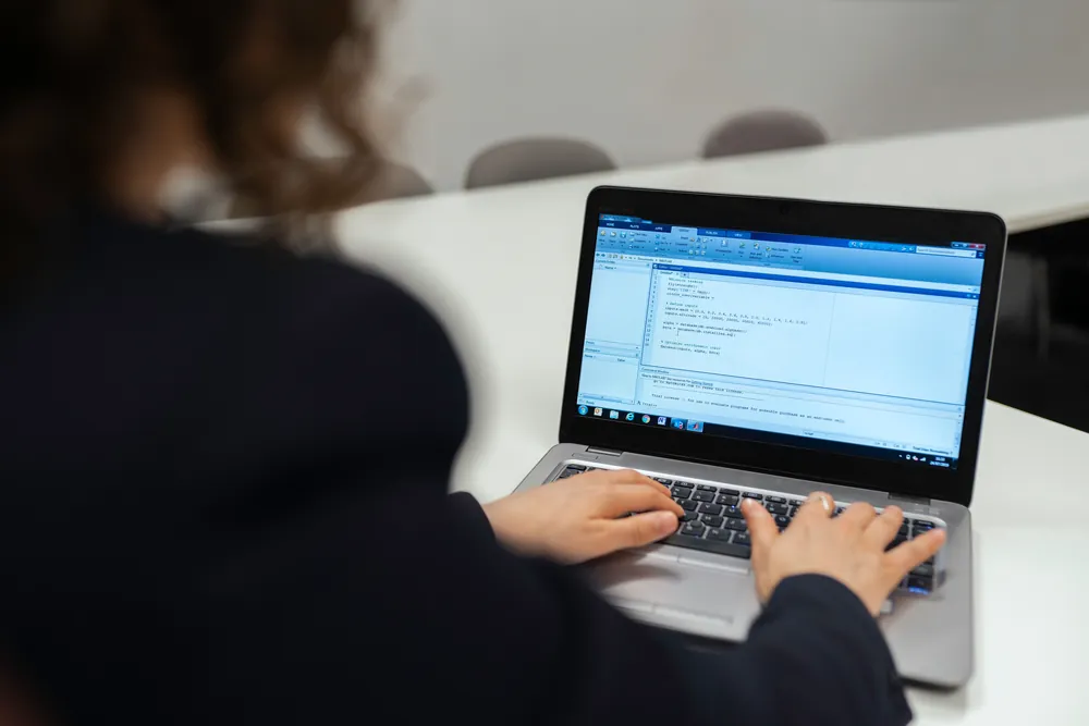 A founder coding independently on a laptop without a technical co-founder or engineering team, illustrating solo vibe coding in 2026